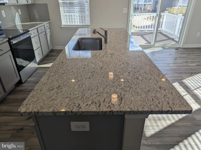a kitchen with a sink a counter top space and cabinets