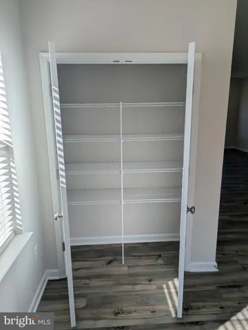 a view of walk in closet with empty racks