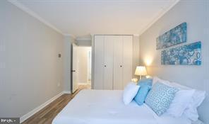 1280 21st Street Northwest, Unit 109 Washington, DC 20036 - Photo 12 of 22 a bedroom with a bed and a painting on the wall