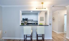 1280 21st Street Northwest, Unit 109 Washington, DC 20036 - Photo 16 of 22 a kitchen with stainless steel appliances a sink and cabinets