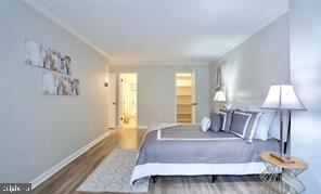 1280 21st Street Northwest, Unit 109 Washington, DC 20036 - Photo 8 of 22 a spacious bedroom with a bed and a lamp