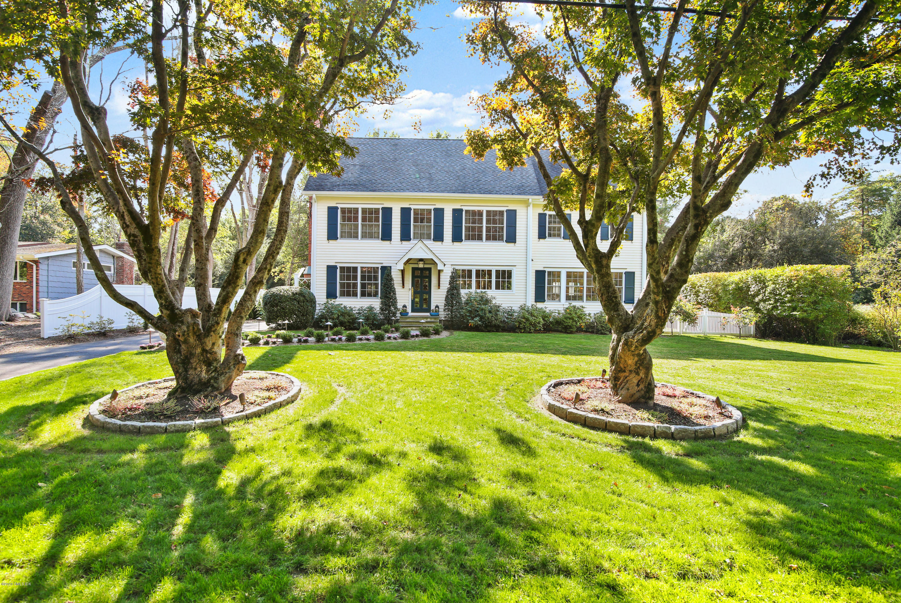 20 Scott Road Greenwich, CT 06831 - Photo 1 of 42 a front view of a house with a yard table and chairs