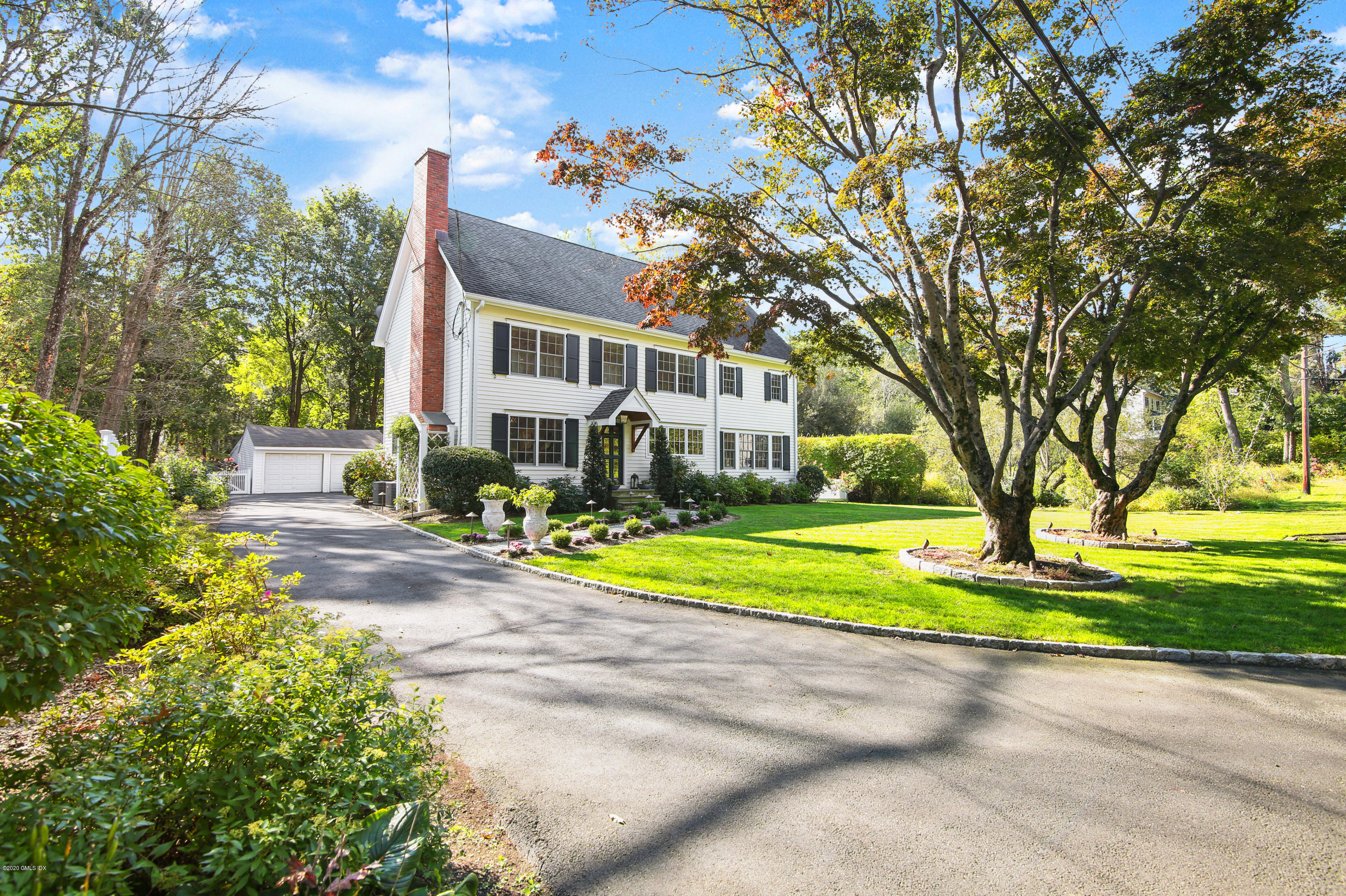 20 Scott Road Greenwich, CT 06831 - Photo 2 of 42 a front view of a house with a yard and trees