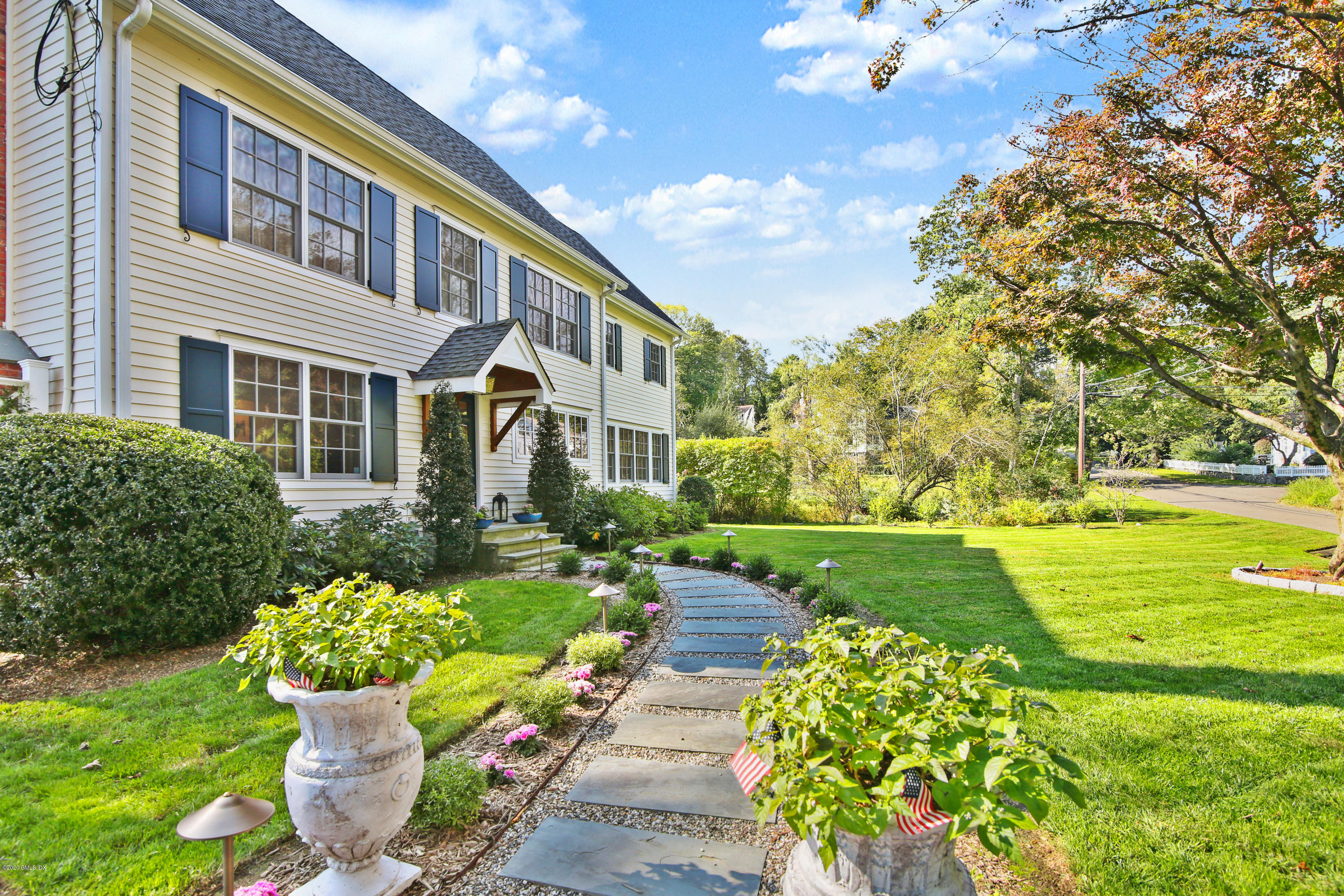 20 Scott Road Greenwich, CT 06831 - Photo 3 of 42 a front view of a house with a garden