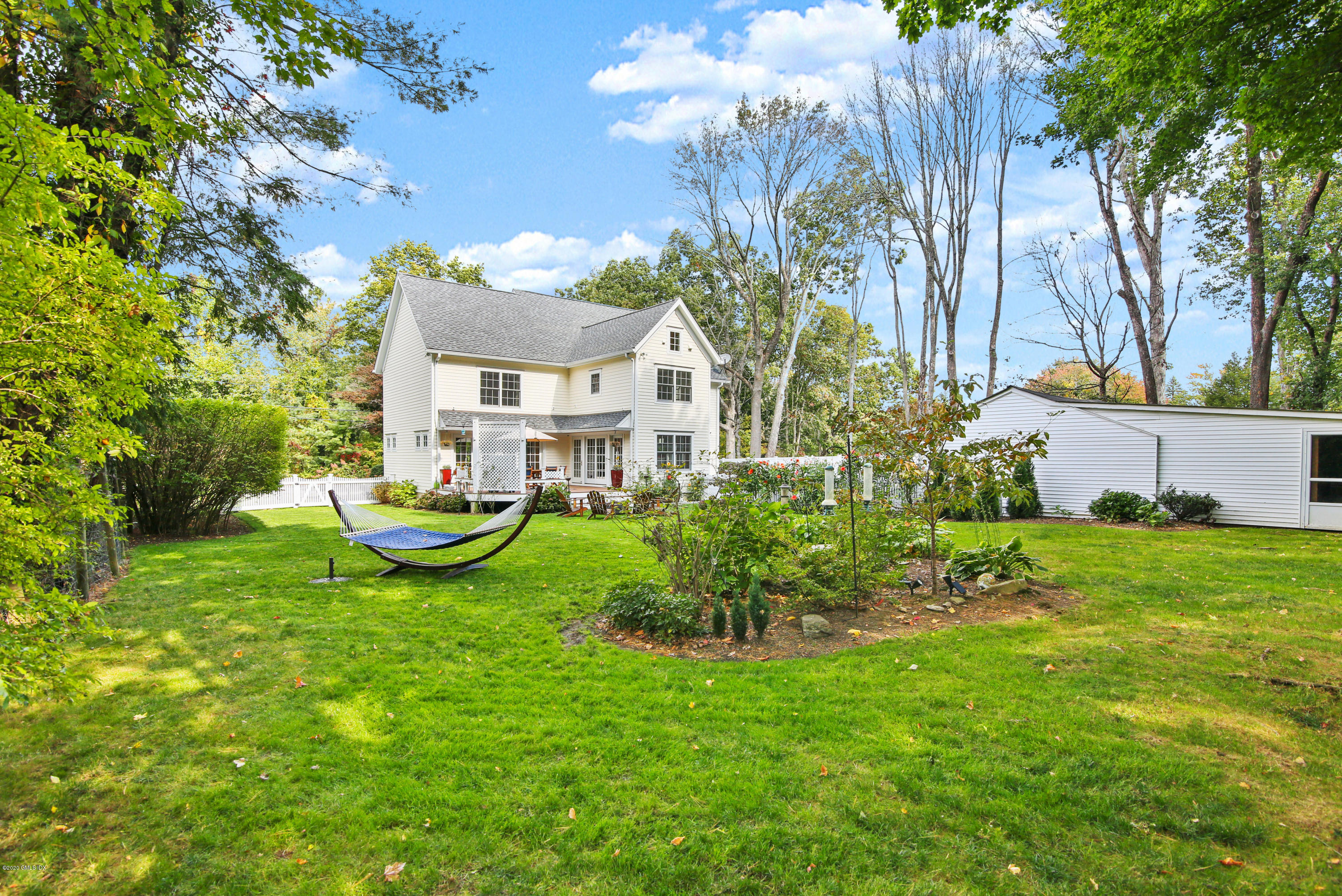 20 Scott Road Greenwich, CT 06831 - Photo 35 of 42 a view of a house with a yard table and chairs