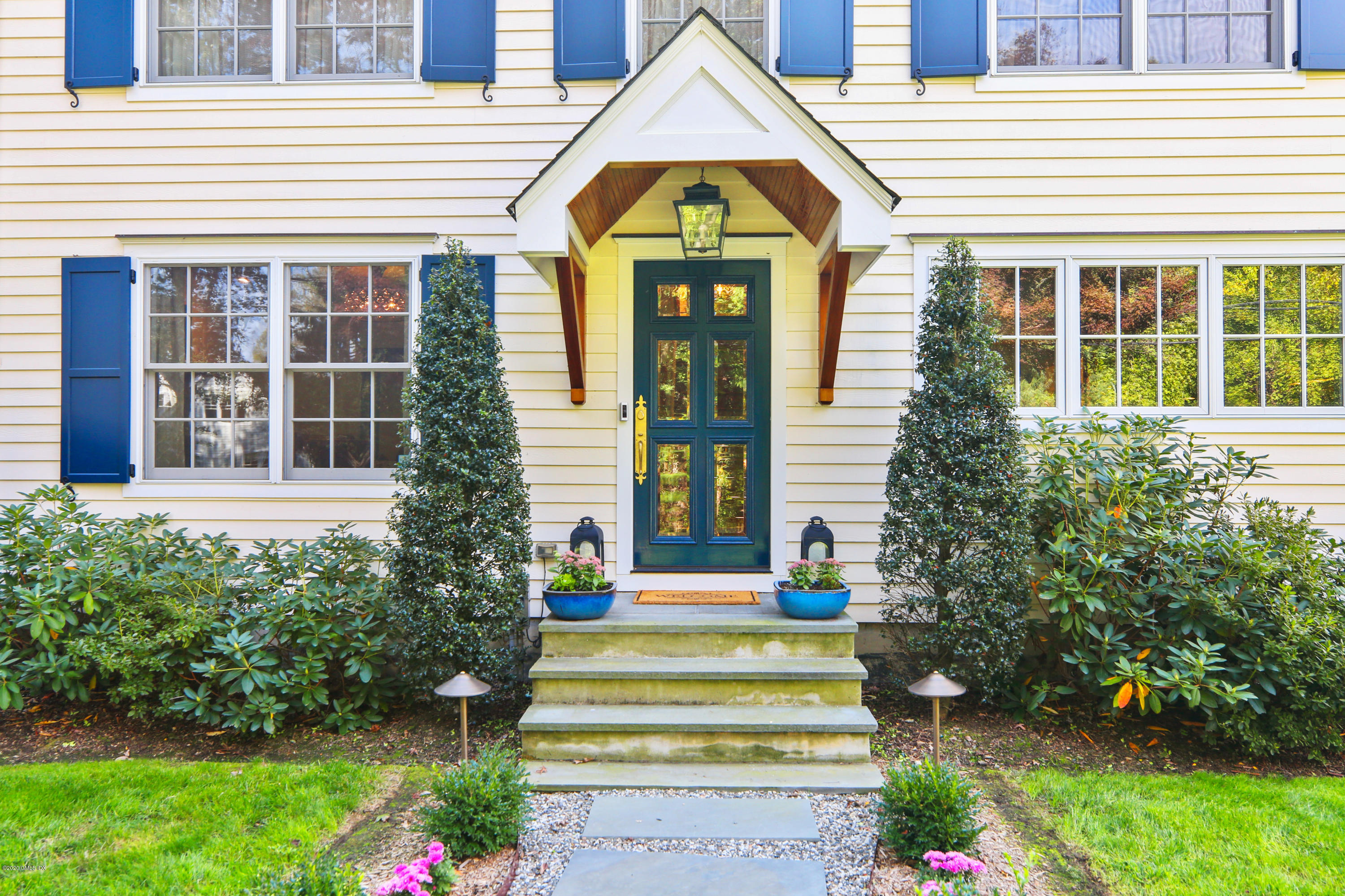 20 Scott Road Greenwich, CT 06831 - Photo 4 of 42 a front view of a house with a yard and potted plants
