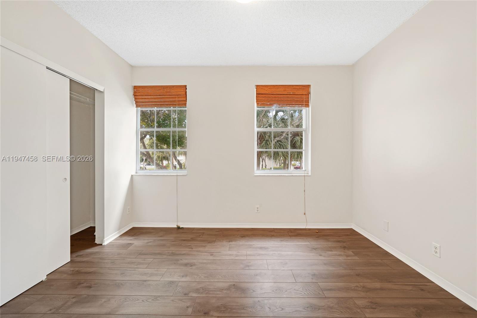 4 Key W Court, Unit 4 Weston, FL 33326 - Photo 18 of 29 an empty room with wooden floor and windows