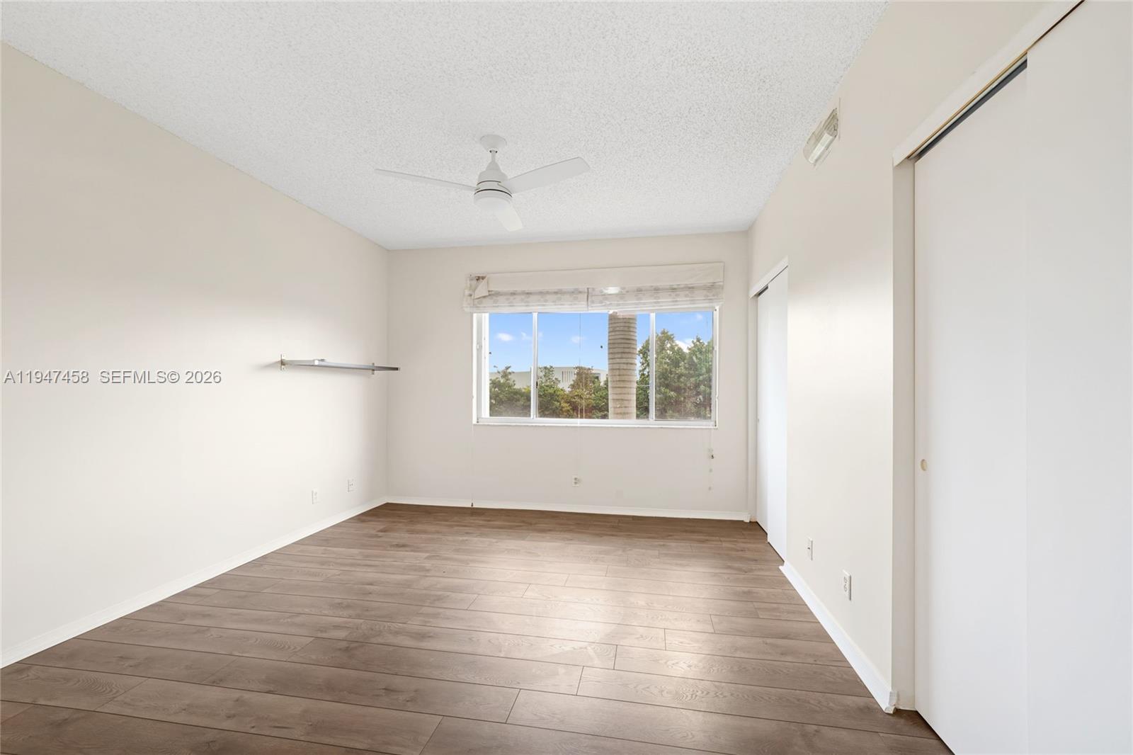 4 Key W Court, Unit 4 Weston, FL 33326 - Photo 21 of 29 a view of an empty room with wooden floor and windows