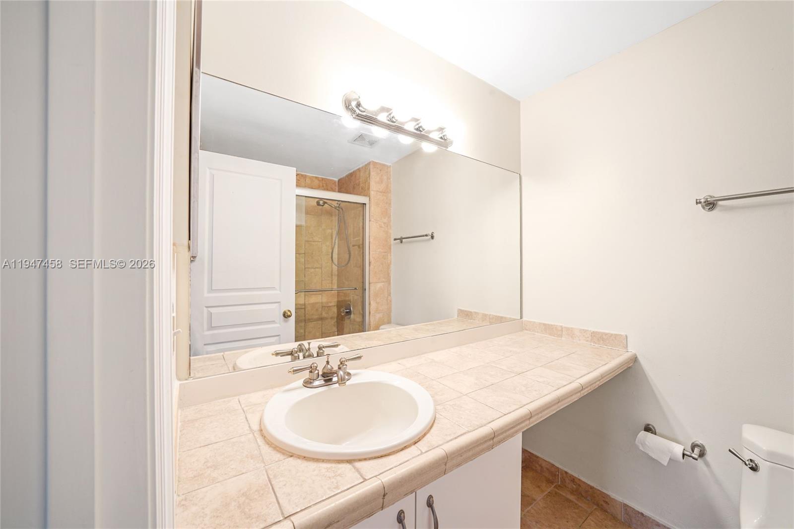 4 Key W Court, Unit 4 Weston, FL 33326 - Photo 25 of 29 a bathroom with a sink and a mirror