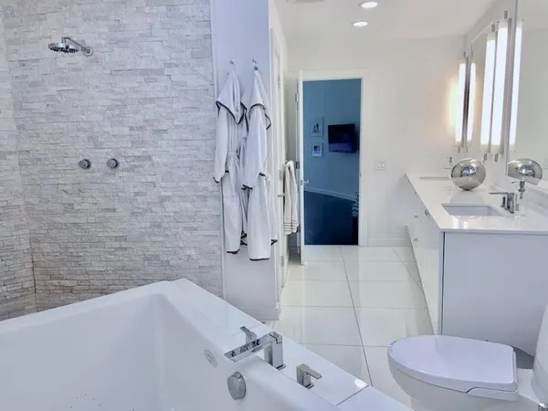 a bathroom with a sink toilet and shower