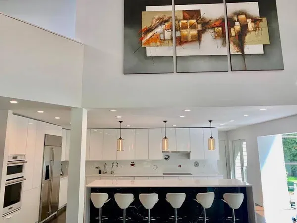 a kitchen with stainless steel appliances kitchen island granite countertop a sink and cabinets