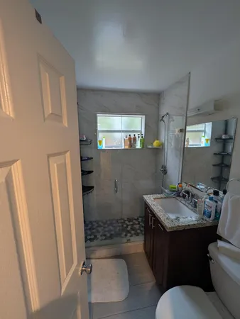 a bathroom with a sink toilet and shower