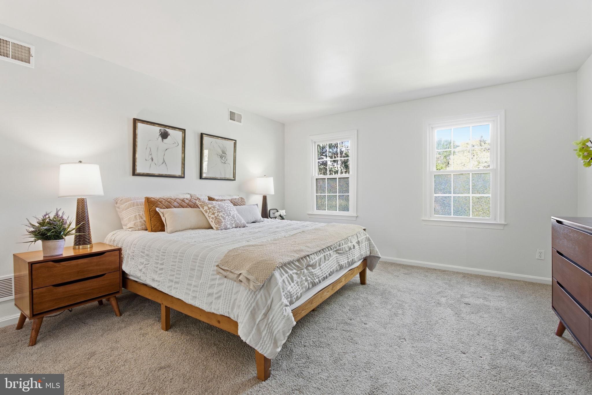 15101 Redgate Drive Silver Spring, MD 20905 - Photo 22 of 39 a spacious bedroom with a bed and a window
