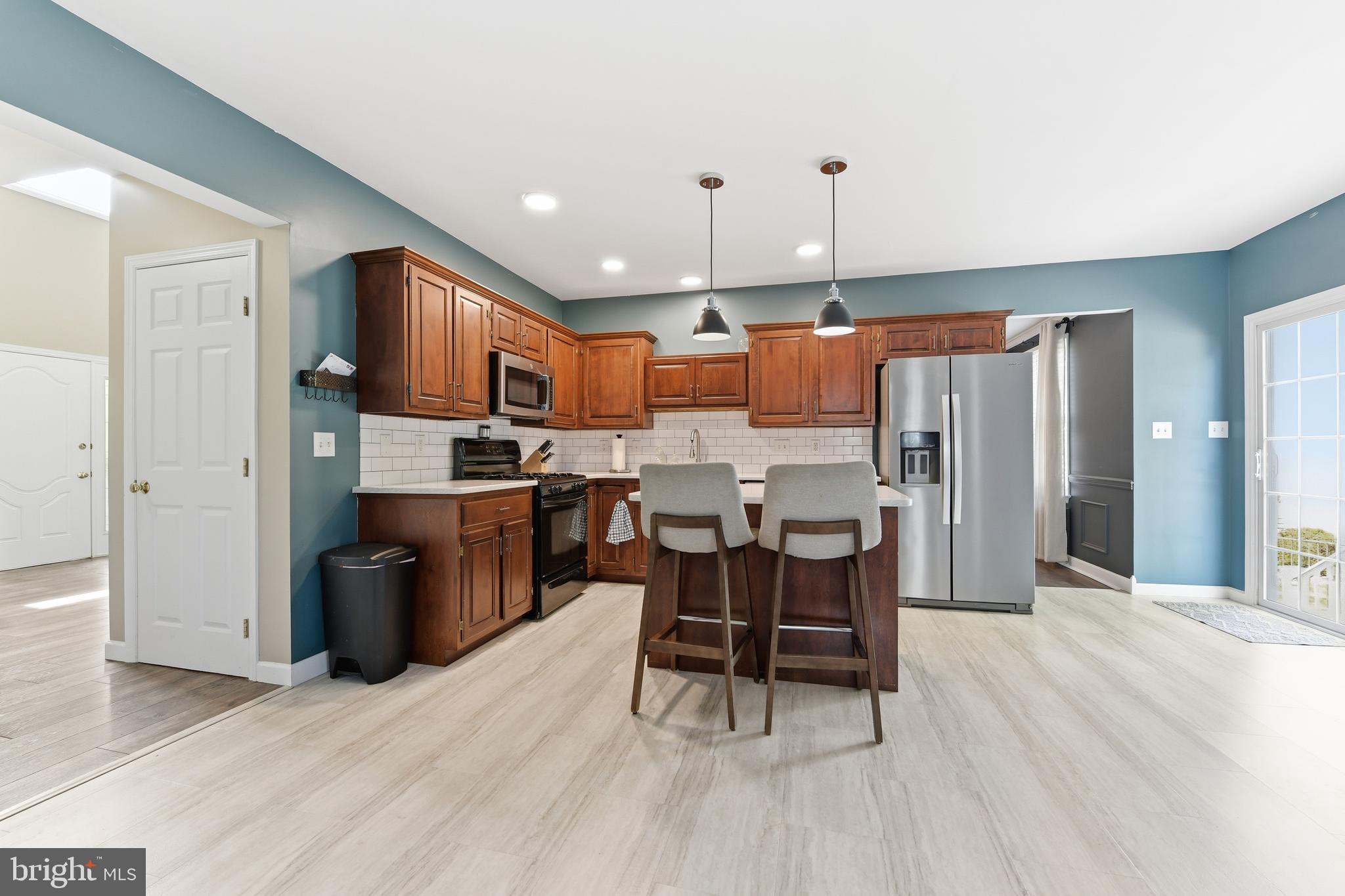 3121 South Wagner Circle Sinking Spring, PA 19608 - Photo 2 of 30 a kitchen with stainless steel appliances kitchen island granite countertop a refrigerator a stove top oven and a sink with granite countertops