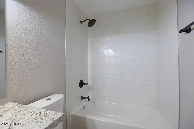 a bathroom with a bathtub and shower