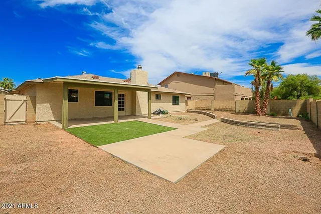 a front view of a house with a garden and yard