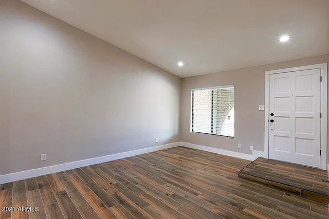 a view of wooden floor and windows in a room