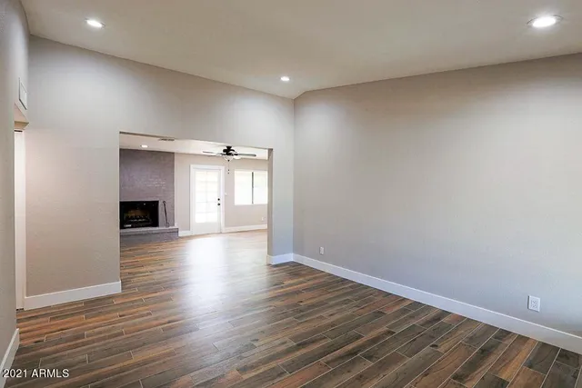 wooden floor in an empty room with a window