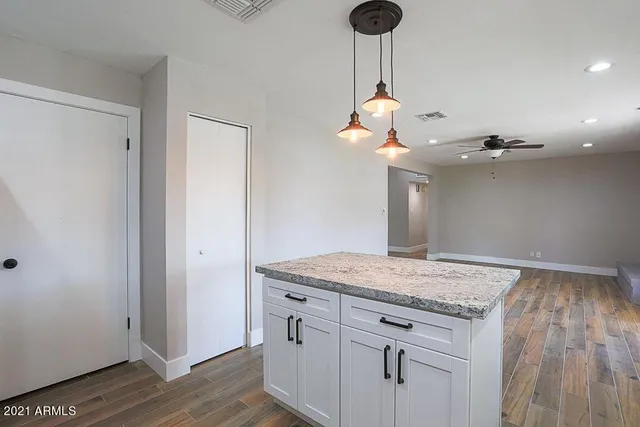 a view of a kitchen counter space and wooden floor