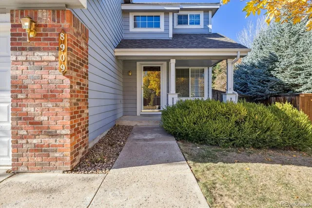 a view of a brick house with large windows