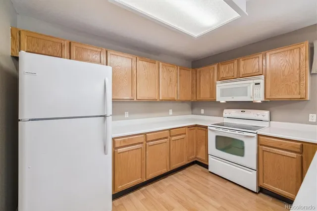 a white refrigerator freezer sitting inside of a kitchen