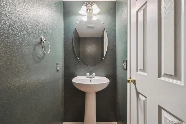 a bathroom with a sink a mirror and shower