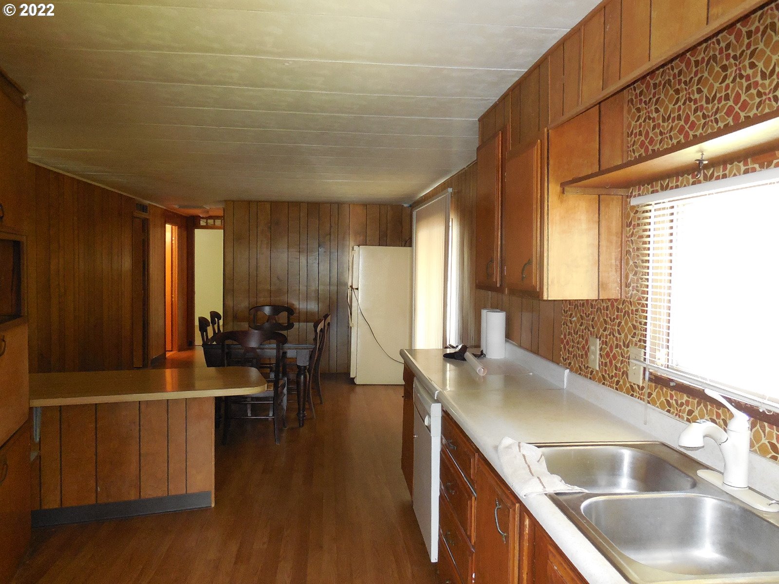 53785 West Crockett Road Milton Freewater, OR 97862 - Photo 7 of 14 a kitchen with sink cabinets and wooden floor