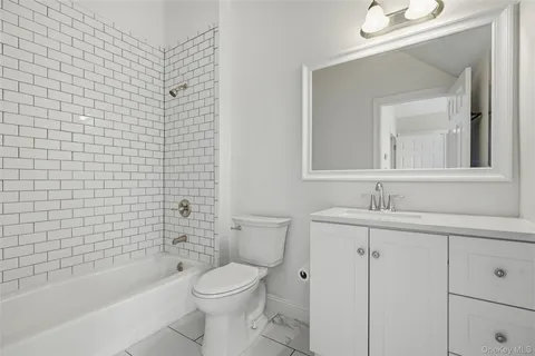 a bathroom with a toilet a sink a mirror a shower and bathtub