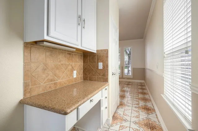 a bathroom with granite countertop a sink and a mirror