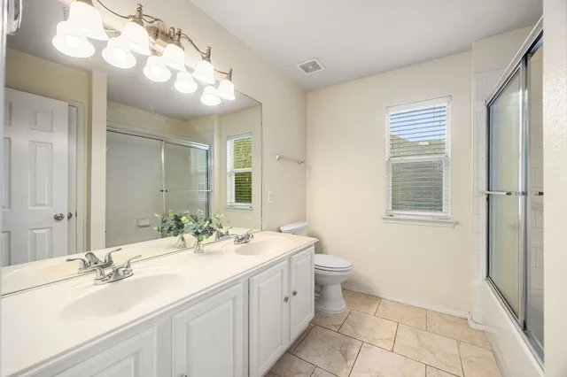 a bathroom with a sink double vanity and a mirror
