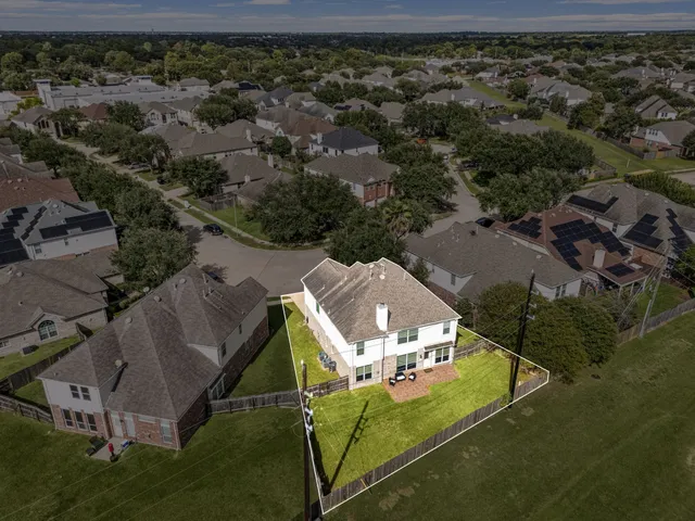 an aerial view of a house with a yard