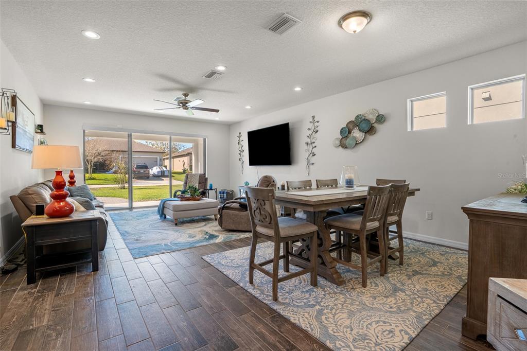 2825 Murray Pass Odessa, FL 33556 - Photo 12 of 43 a view of a dining room with furniture a rug and wooden floor