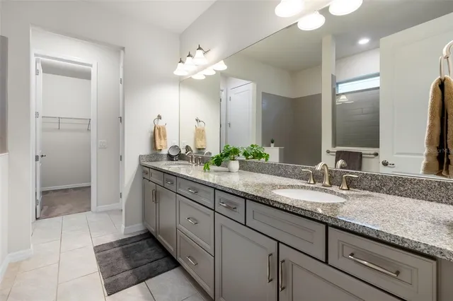 a bathroom with double sink and a mirror