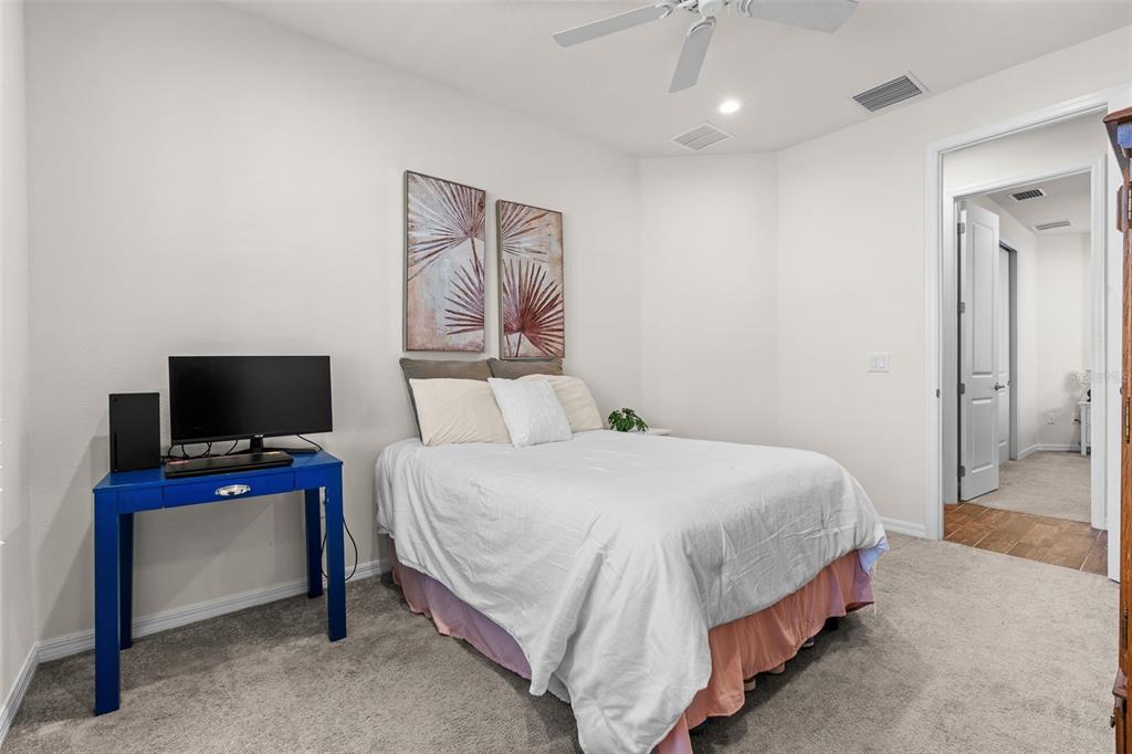 2825 Murray Pass Odessa, FL 33556 - Photo 26 of 43 a bedroom with a bed and a flat screen tv