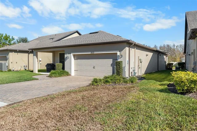 a view of a house with a yard and garage