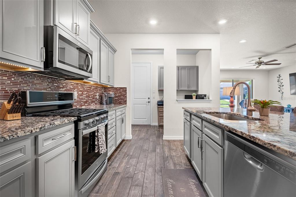2825 Murray Pass Odessa, FL 33556 - Photo 8 of 43 a kitchen with stainless steel appliances granite countertop a stove and a sink