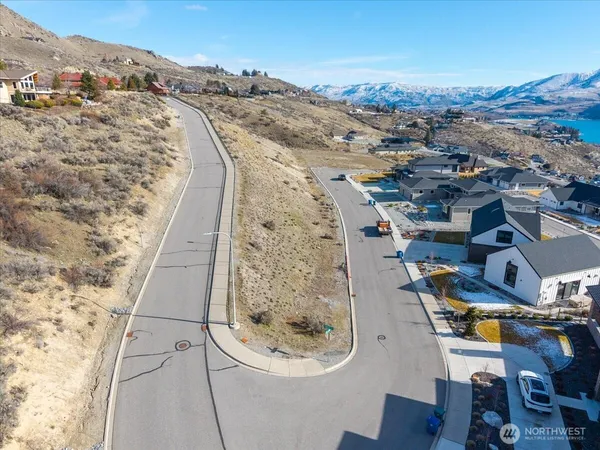 an aerial view of a house with a mountain