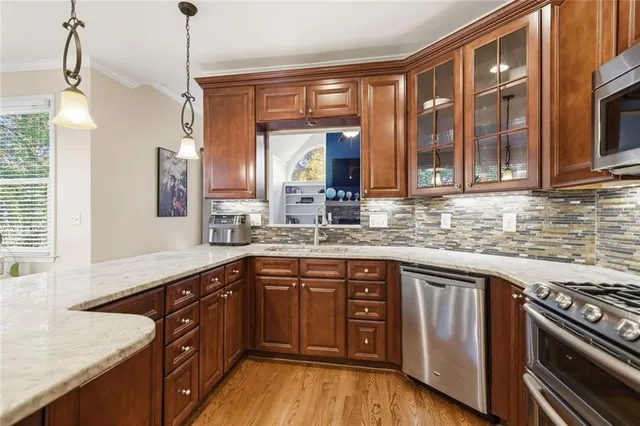 a bedroom with a bed a chandelier and a window