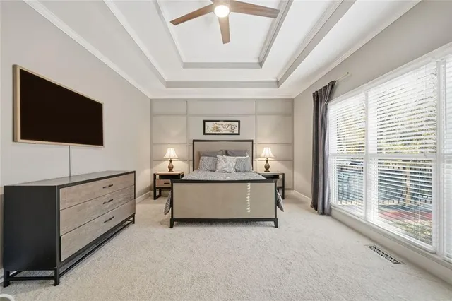 a spacious bathroom with a granite countertop sink a large mirror and a bathtub