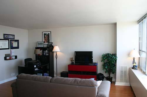 655 West Irving Park Road, Unit 5209 Chicago, IL 60613 - Photo 3 of 15 a living room with furniture and a flat screen tv