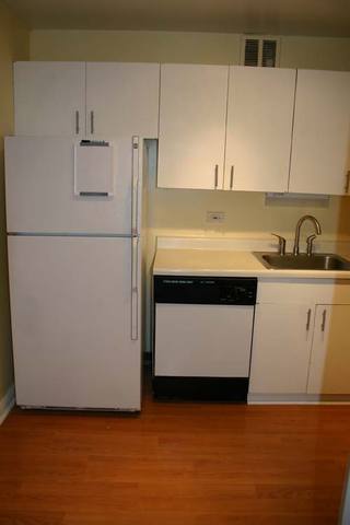 655 West Irving Park Road, Unit 5209 Chicago, IL 60613 - Photo 6 of 15 a kitchen with a sink a stove and a refrigerator