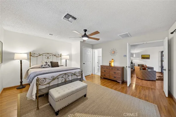 a bedroom with furniture and a wooden floor