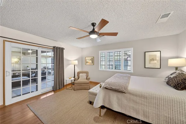 a bedroom with a bed and glass walk in closet