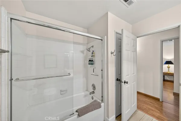 a bathroom with a glass shower door