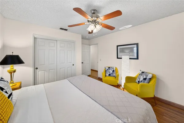 a bedroom with a bed and a ceiling fan