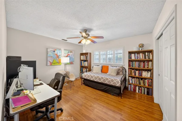 a bedroom with furniture and a book shelf
