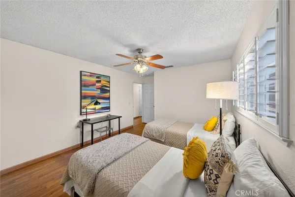 a bedroom with a bed table and window