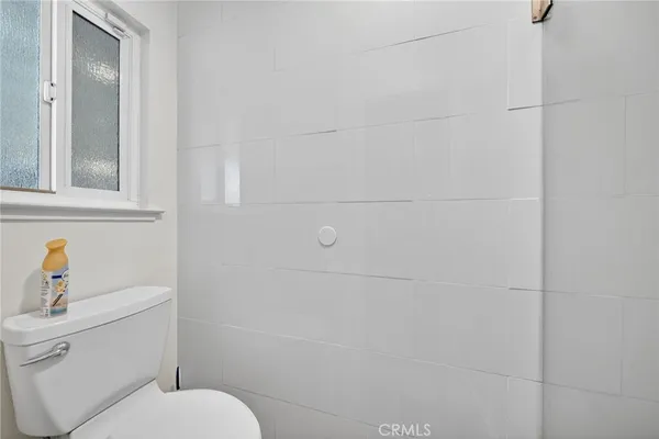 a white toilet sitting next to a bathroom sink