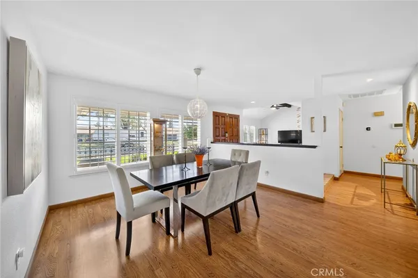 a view of a dining room with furniture and wooden floor