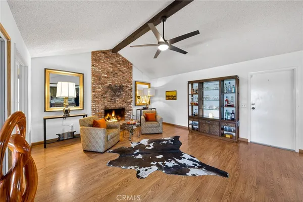 a living room with furniture large window and a fireplace